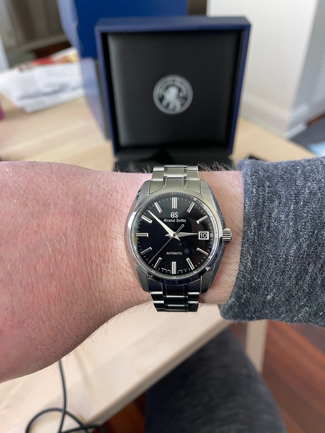 Grand Seiko SBGR317 black-dial automatic on the wrist — photo: Uncommon Artifact